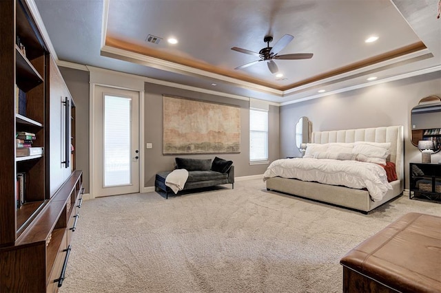 carpeted bedroom featuring a tray ceiling, access to exterior, ceiling fan, and crown molding