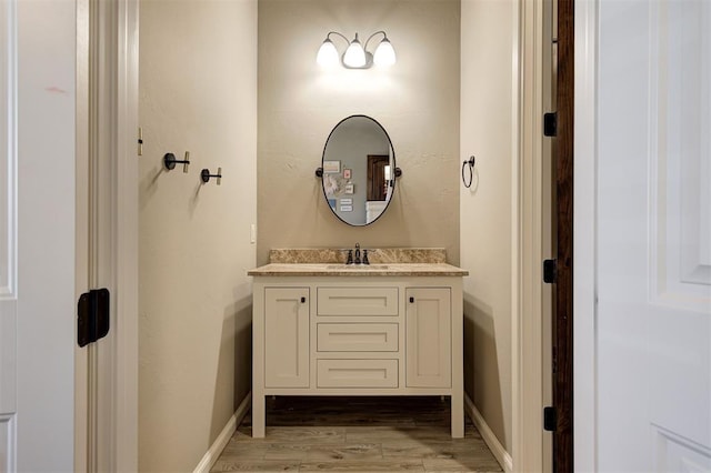 bathroom with hardwood / wood-style floors and vanity