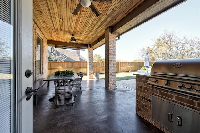 view of patio with ceiling fan and area for grilling