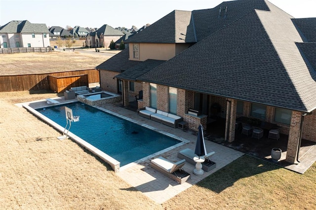 view of pool with a patio area and an in ground hot tub