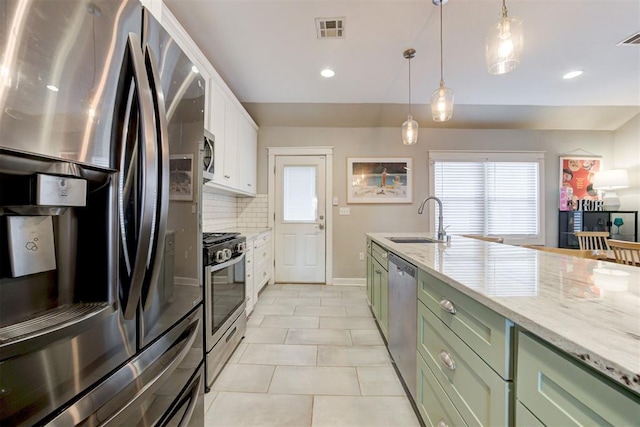 kitchen featuring white cabinetry, sink, stainless steel appliances, decorative light fixtures, and decorative backsplash