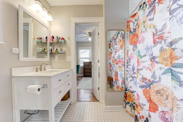 bathroom featuring hardwood / wood-style flooring, ceiling fan, and vanity