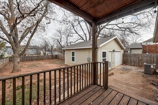 wooden terrace featuring central AC, a garage, and an outdoor structure