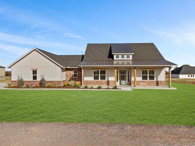 modern farmhouse style home featuring a porch and a front lawn