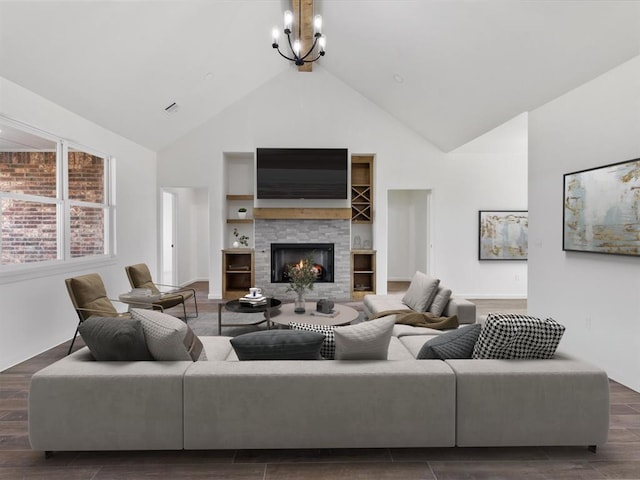 living room with dark hardwood / wood-style floors, high vaulted ceiling, and a notable chandelier