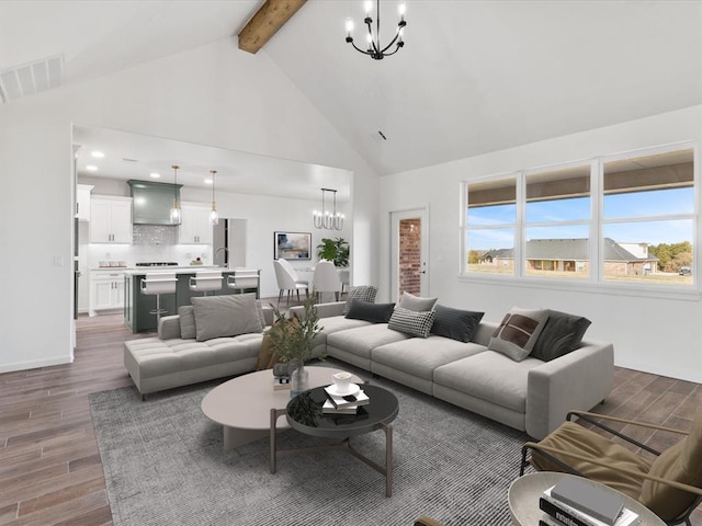 living room with beam ceiling, dark hardwood / wood-style flooring, high vaulted ceiling, and a notable chandelier