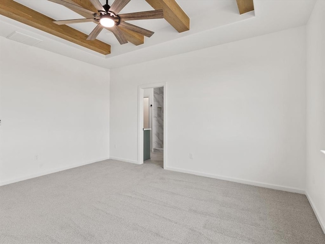 unfurnished room featuring beamed ceiling, ceiling fan, and light colored carpet