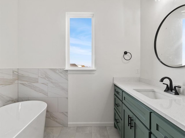 bathroom with vanity, tile walls, and a bathing tub