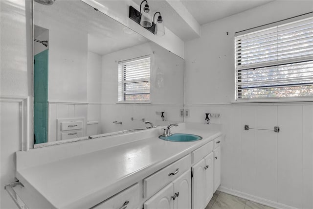 bathroom with vanity, a textured ceiling, and a wealth of natural light