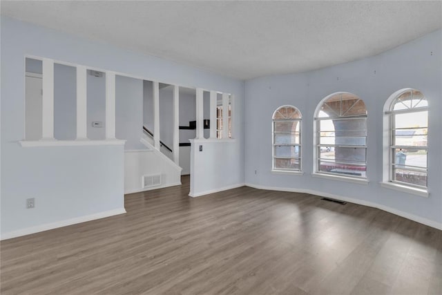 empty room featuring hardwood / wood-style floors and a textured ceiling