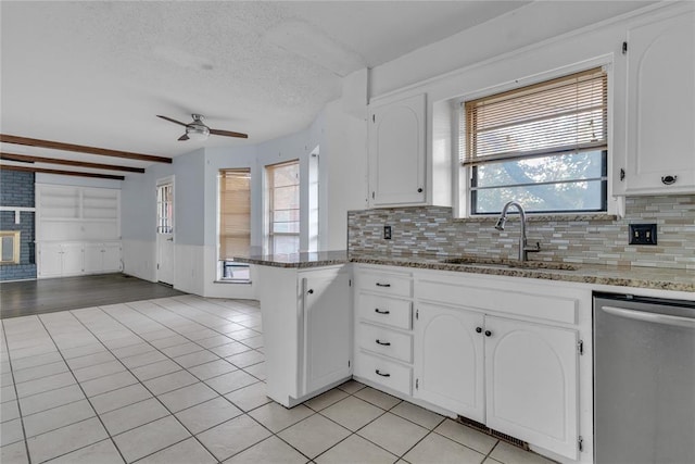 kitchen featuring white cabinetry, dishwasher, a healthy amount of sunlight, and sink