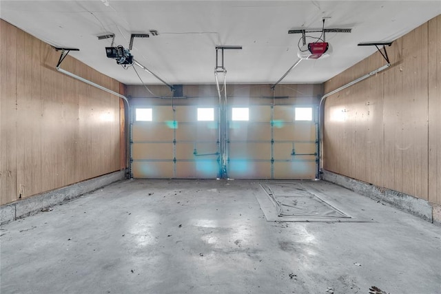 garage featuring wooden walls and a garage door opener