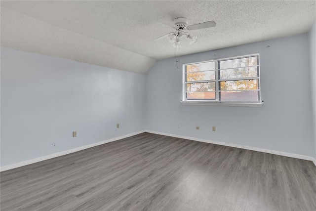 additional living space featuring hardwood / wood-style floors, a textured ceiling, ceiling fan, and lofted ceiling