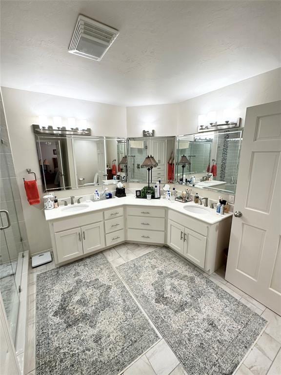 bathroom featuring vanity and a shower with shower door