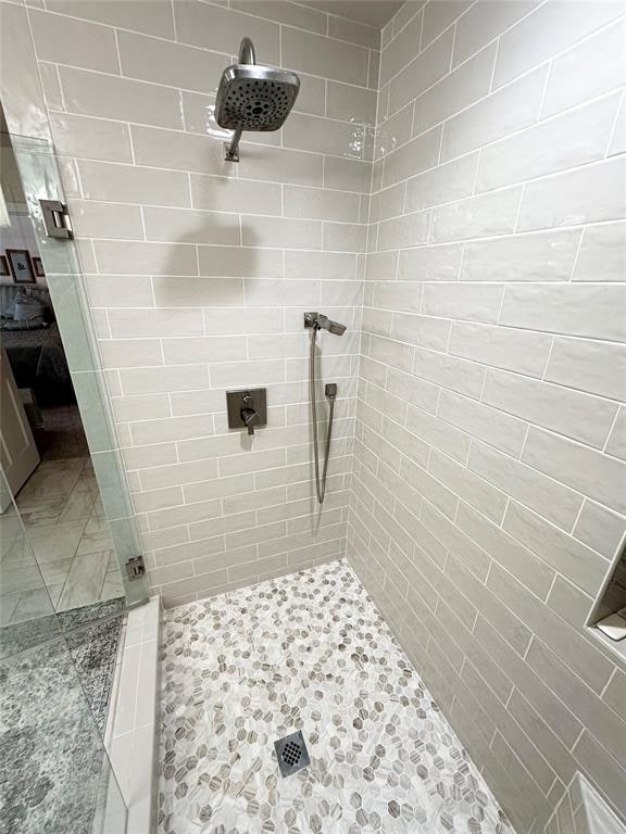 bathroom with a tile shower