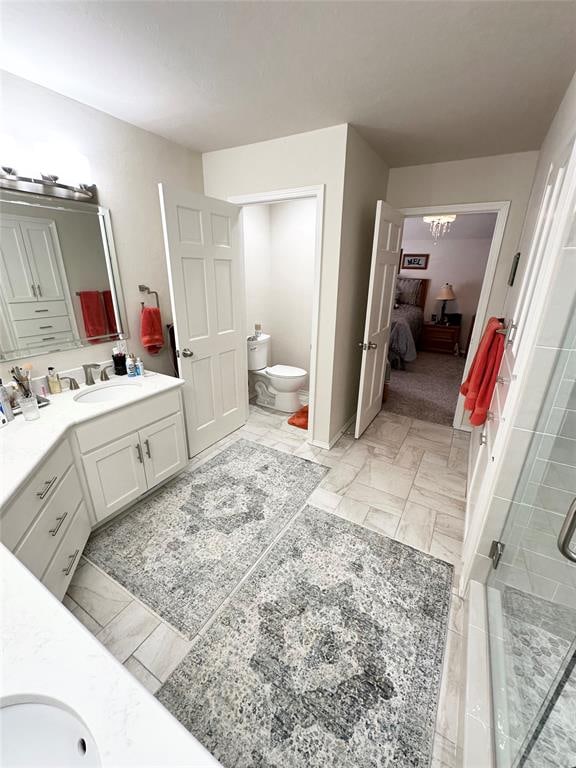 bathroom with vanity and a shower with shower door