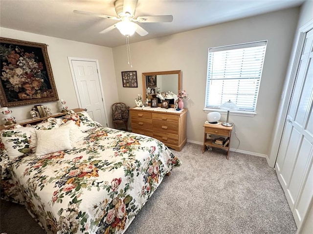 carpeted bedroom with ceiling fan and a closet