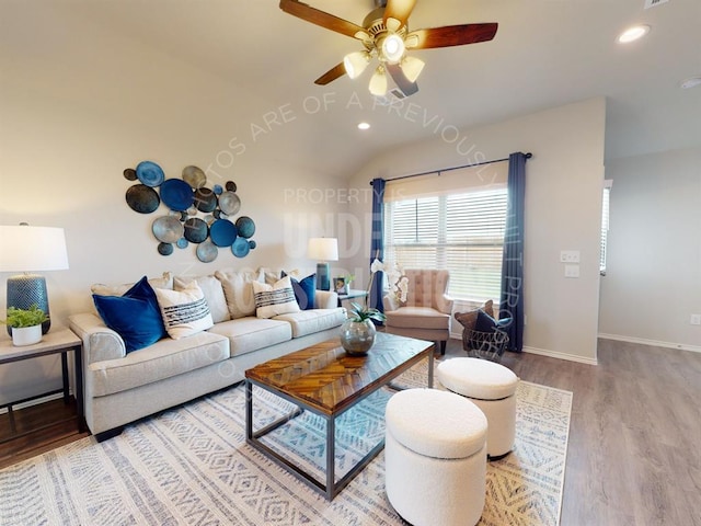 living room with ceiling fan, vaulted ceiling, and hardwood / wood-style flooring