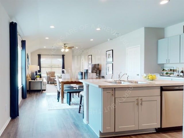 kitchen with sink, dishwasher, ceiling fan, and light wood-type flooring