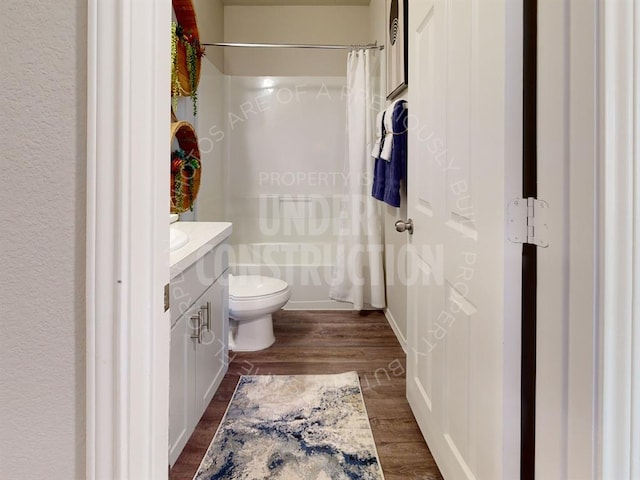 full bathroom with wood-type flooring, vanity, toilet, and shower / bath combo with shower curtain