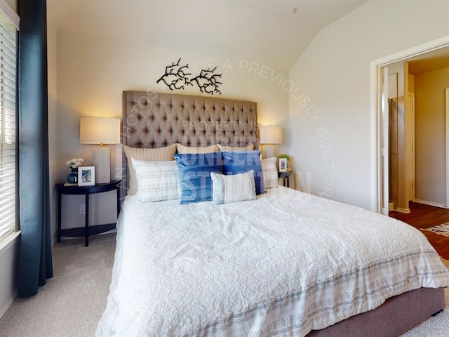 bedroom featuring carpet and lofted ceiling