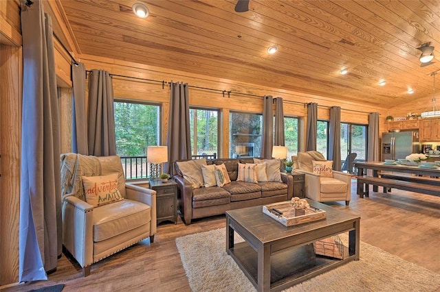 living room featuring wooden ceiling, wooden walls, wood-type flooring, and vaulted ceiling