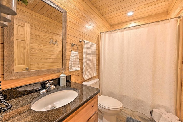 bathroom featuring vanity, wood walls, wooden ceiling, a shower with shower curtain, and toilet