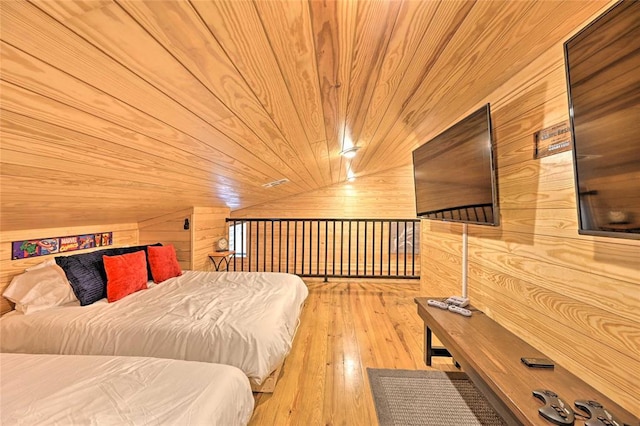 bedroom featuring wooden walls, wooden ceiling, lofted ceiling, and light hardwood / wood-style floors