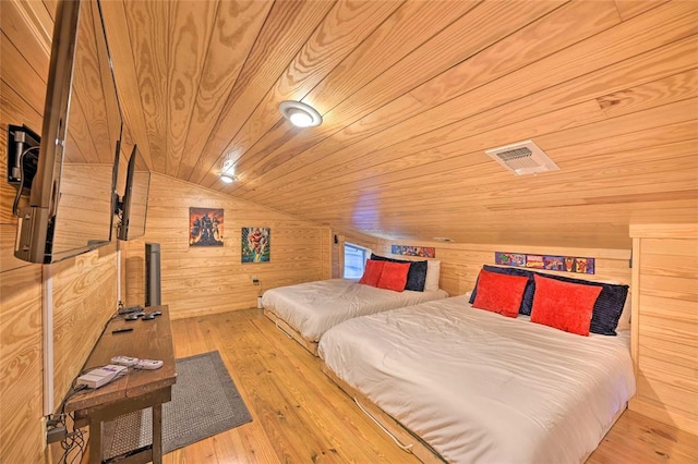 bedroom with wood walls, wooden ceiling, lofted ceiling, and light wood-type flooring