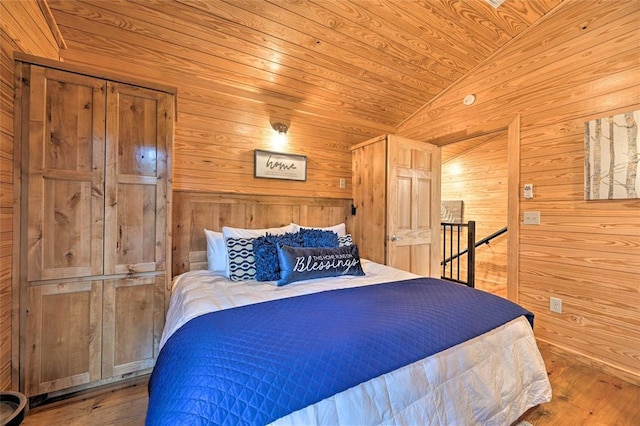 bedroom featuring wood ceiling, light wood-type flooring, lofted ceiling, and wooden walls