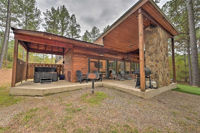 exterior space with a hot tub and grilling area