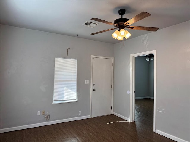 spare room with dark hardwood / wood-style floors and ceiling fan