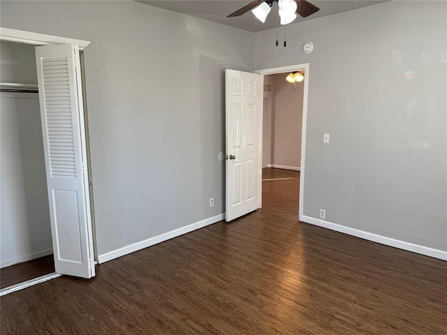 unfurnished bedroom featuring a closet, ceiling fan, and dark hardwood / wood-style flooring