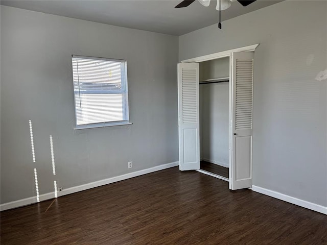 unfurnished bedroom with dark hardwood / wood-style floors, ceiling fan, and a closet