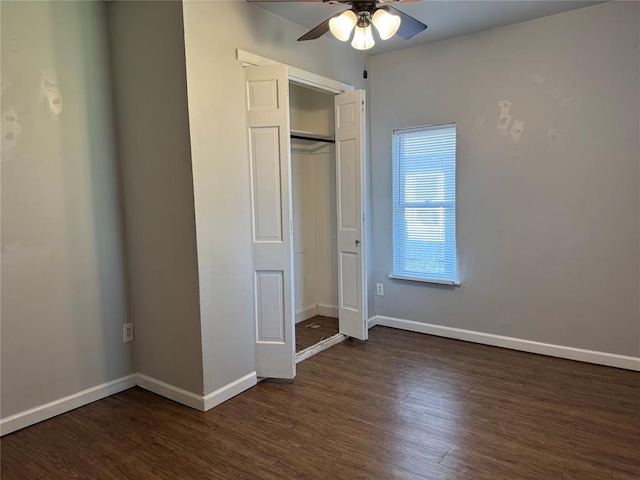 unfurnished bedroom featuring ceiling fan, a closet, and dark wood-type flooring