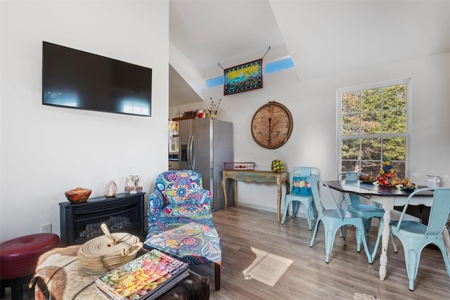 interior space with light hardwood / wood-style flooring and lofted ceiling