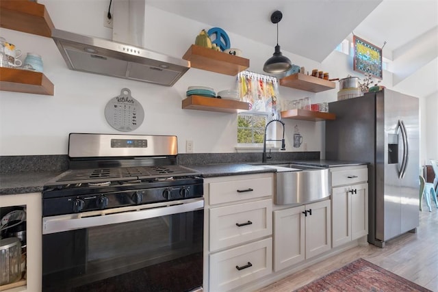 kitchen featuring island exhaust hood, stainless steel appliances, sink, light hardwood / wood-style flooring, and white cabinetry