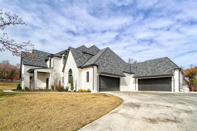 french provincial home with a garage