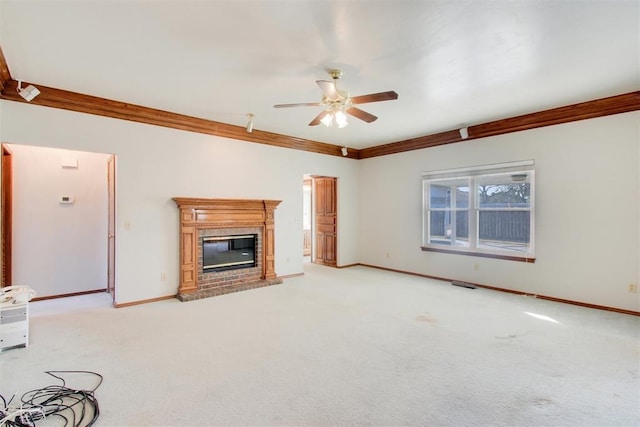 unfurnished living room with ceiling fan, a fireplace, light colored carpet, and ornamental molding