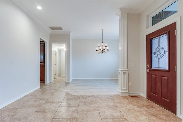 entryway featuring ornate columns, ornamental molding, and a notable chandelier