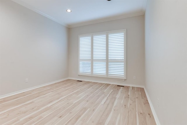 unfurnished room with crown molding and light hardwood / wood-style flooring