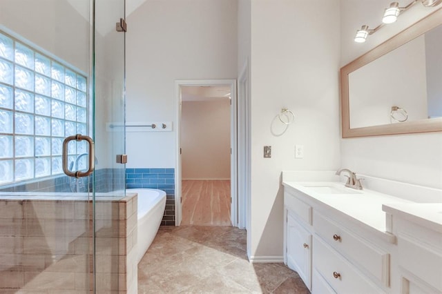 bathroom with tile patterned flooring, vanity, and separate shower and tub