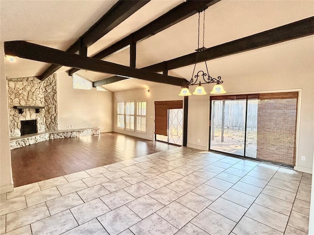 unfurnished living room featuring a fireplace, lofted ceiling with beams, light hardwood / wood-style floors, and a chandelier