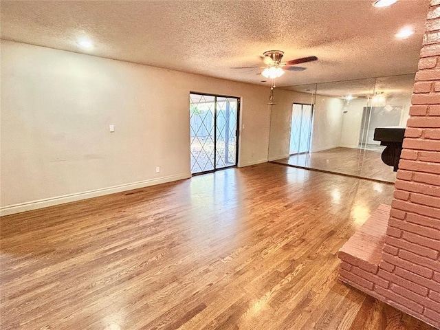 unfurnished living room featuring hardwood / wood-style floors, a textured ceiling, and ceiling fan