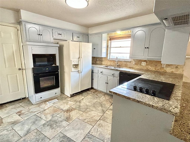 kitchen featuring sink, ventilation hood, a textured ceiling, decorative backsplash, and black appliances