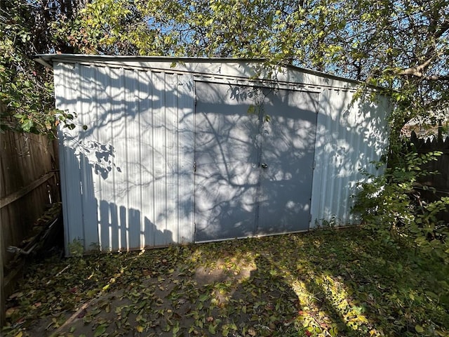 view of side of property featuring a storage unit