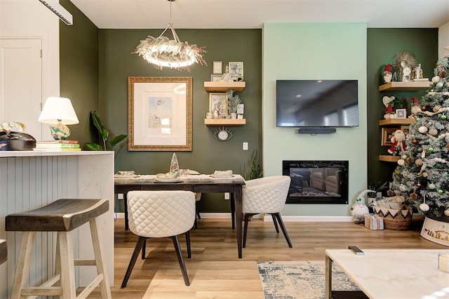 dining space with a chandelier and light hardwood / wood-style floors