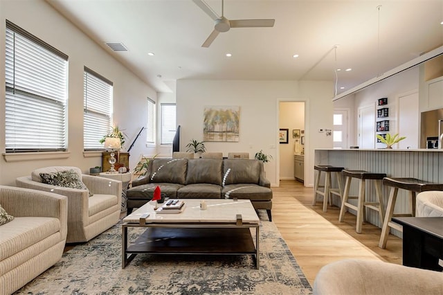 living room featuring ceiling fan and light hardwood / wood-style floors