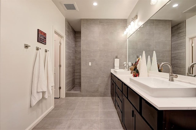 bathroom with tile patterned floors, vanity, and tile walls