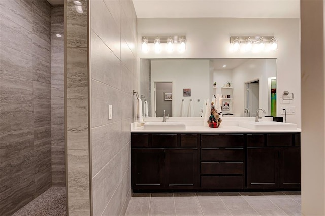 bathroom featuring tile patterned flooring, vanity, and tile walls